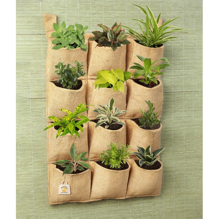 Vertical wall-hanging jute planter with twelve pockets, each holding a small plant