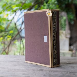 FF 018 C standing exterior with a muted-brown cover, tan edging, dark floral side band, pale front patch and hanging tag.