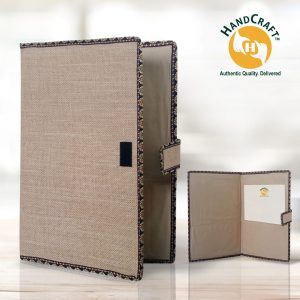 FF 004 composite: plain beige cover with dark patterned edging, a side tab and front patch; inset shows two inner pockets and a white paper.