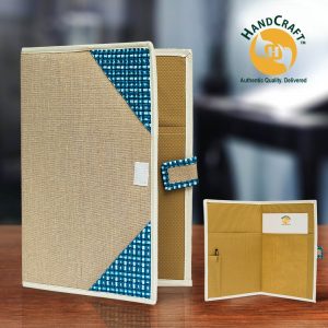 FF 009 C composite: beige cover with blue-and-white corners and cream edging; interior inset with two pockets, a pen holder, pen and paper.
