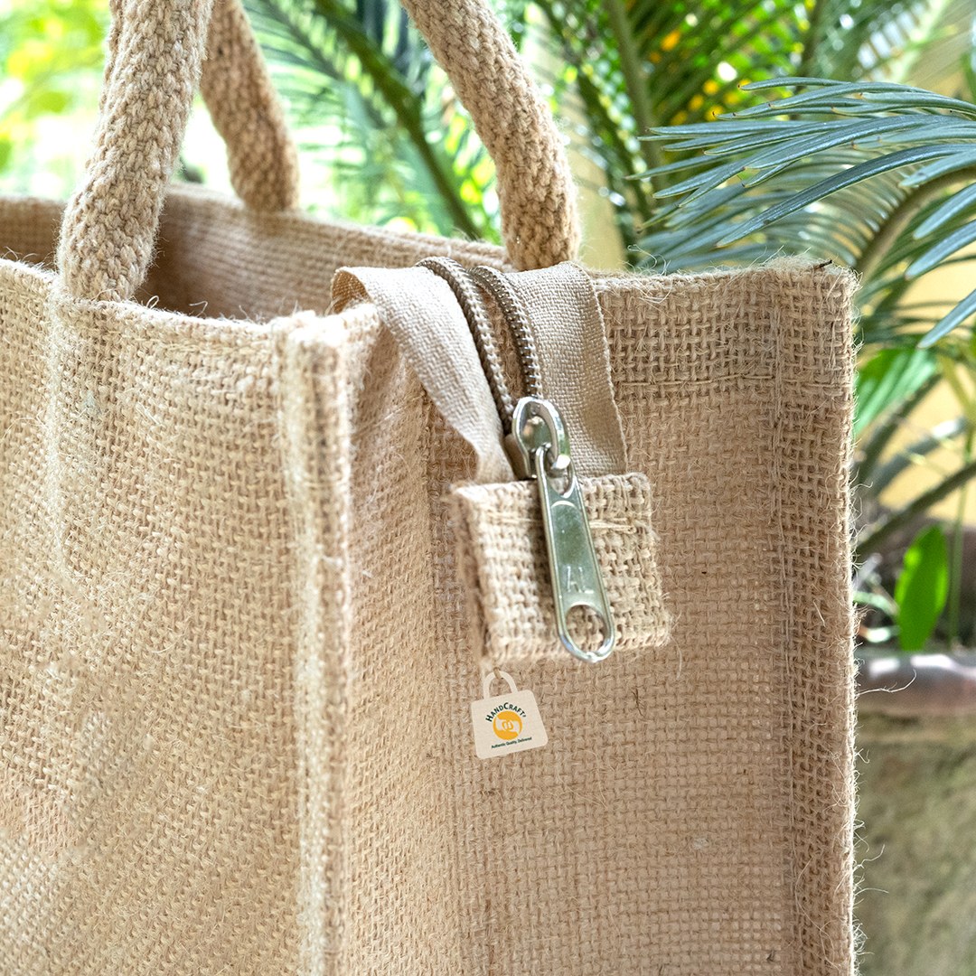 Close-up of a zip on a natural-colour bag.