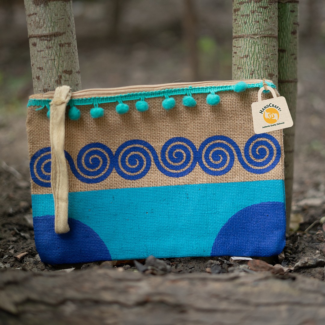 Natural-colour zip pouch with blue spiral print and turquoise pom-pom trim.